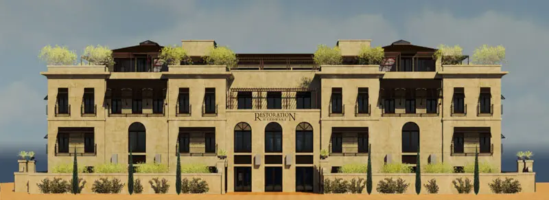 A three-story beige building with arched windows and balconies, featuring greenery and a sign reading "Restoration Hardware" on the facade, stands prominently in North Las Vegas near Adamik Electric.